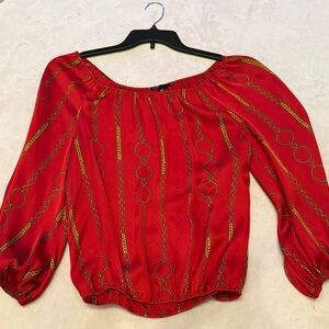 Red off the shoulder blouse with gold chain design